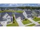 Aerial view of homes in a community with a pond, showcasing neighborhood layout and green spaces at 206 Camellia Bloom Dr, Moncks Corner, SC 29461