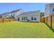 Spacious, well-maintained backyard with green grass and a wooden fence at 206 Camellia Bloom Dr, Moncks Corner, SC 29461