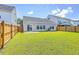 Lush green backyard enclosed by a wooden fence, perfect for outdoor activities at 206 Camellia Bloom Dr, Moncks Corner, SC 29461