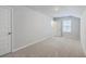 Cozy bedroom with neutral walls, soft carpeting, and a window offering natural light at 206 Camellia Bloom Dr, Moncks Corner, SC 29461