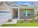Charming home with a brick facade, covered entrance, and well-maintained landscaping at 206 Camellia Bloom Dr, Moncks Corner, SC 29461