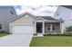 Charming single-story home featuring a one-car garage, inviting entrance, and well-manicured lawn at 206 Camellia Bloom Dr, Moncks Corner, SC 29461