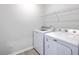 Well-equipped laundry room features a modern washer, dryer, and convenient wire shelving for storage at 206 Camellia Bloom Dr, Moncks Corner, SC 29461