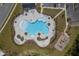 Overhead shot of a modern, resort-style community pool, playground, and clubhouse at 206 Camellia Bloom Dr, Moncks Corner, SC 29461