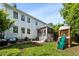 Green backyard with an outdoor kitchen, seating, and a playground at 2152 Pentland Dr, Charleston, SC 29412