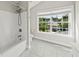 Bathroom featuring a bathtub and shower combination, plus a large window with views at 2152 Pentland Dr, Charleston, SC 29412