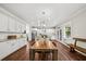 This open-concept kitchen features white cabinets, stainless steel appliances, and a large center island at 2152 Pentland Dr, Charleston, SC 29412