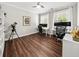 Home office space with dark wood floors, white trim, a shelving unit, and two windows at 2152 Pentland Dr, Charleston, SC 29412