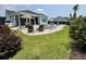 Beautifully landscaped backyard featuring a screen porch, patio, a built in jacuzzi and lush green grass at 2221 Generals St, Charleston, SC 29492
