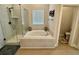 Bright bathroom featuring a soaking tub, separate shower, and neutral tile at 2221 Generals St, Charleston, SC 29492