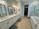 Luxurious bathroom with double vanity, tub, glass shower and walk-in closet at 2221 Generals St, Charleston, SC 29492