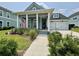 Charming home featuring blue siding, white trim, inviting front porch and a well-manicured front yard at 2221 Generals St, Charleston, SC 29492