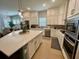 Bright, modern kitchen featuring white cabinets, stainless steel appliances, and a large island with seating at 2221 Generals St, Charleston, SC 29492