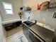 Spacious laundry room with front loading washer and dryer and custom shelving at 2221 Generals St, Charleston, SC 29492