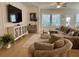 Cozy living room featuring a large sectional sofa, modern furnishings, light hardwood floors and a ceiling fan at 2221 Generals St, Charleston, SC 29492
