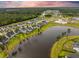 A community view featuring a resort-style pool, lush landscaping, and access to a large lake at 223 Granton Edge Ln, Summerville, SC 29486