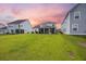 Lush green backyard between houses featuring healthy grass and a view of the back of a home with a screened in porch at 223 Granton Edge Ln, Summerville, SC 29486