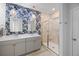 Stylish bathroom boasts double sinks, unique lighting, and a glass-enclosed shower at 223 Granton Edge Ln, Summerville, SC 29486