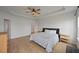 Bright bedroom features a ceiling fan, hardwood floors, and neutral decor for a modern feel at 223 Granton Edge Ln, Summerville, SC 29486