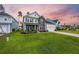 Attractive two-story home with stone and siding exterior, lush green lawn, and inviting curb appeal at 223 Granton Edge Ln, Summerville, SC 29486