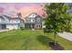 Charming two-story home featuring stone accents, a well-manicured lawn, and a cozy front porch at 223 Granton Edge Ln, Summerville, SC 29486