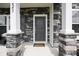 Inviting front porch with stone accents, a stylish front door, and a welcoming entrance to the home at 223 Granton Edge Ln, Summerville, SC 29486