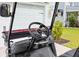 Close up of a golf cart's steering wheel and controls, highlighting its modern features at 223 Granton Edge Ln, Summerville, SC 29486