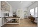 Well-lit home office with a large desk, display shelves, and neutral decor for a productive workspace at 223 Granton Edge Ln, Summerville, SC 29486