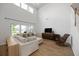Living room with high ceilings, large windows, sectional sofa, and rocking chair at 223 Granton Edge Ln, Summerville, SC 29486
