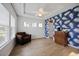 Cozy living room featuring a ceiling fan, natural light, an accent wall, and a comfortable seating arrangement at 223 Granton Edge Ln, Summerville, SC 29486