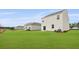 Backyard featuring manicured lawn and home's light siding at 2242 Macallan Blvd, Ravenel, SC 29470