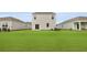 Spacious backyard featuring a lush green lawn and modern home with sliding glass doors for seamless indoor/outdoor living at 2242 Macallan Blvd, Ravenel, SC 29470