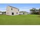 Expansive backyard showcasing a well-maintained lawn and multiple homes, offering a picturesque outdoor living space at 2242 Macallan Blvd, Ravenel, SC 29470