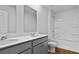 Well-lit bathroom featuring a double sink vanity, mirror, and shower over tub at 2242 Macallan Blvd, Ravenel, SC 29470