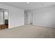 A bedroom featuring neutral carpet, fresh paint, and multiple doorways, offering a versatile living space at 2242 Macallan Blvd, Ravenel, SC 29470