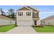 Charming two-story home featuring a two-car garage and well-manicured lawn at 2242 Macallan Blvd, Ravenel, SC 29470