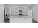 Kitchen features a granite countertop island, stainless steel appliances, and gray cabinets at 2242 Macallan Blvd, Ravenel, SC 29470