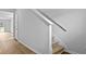 Well-lit staircase with carpeted steps and white handrail leading upstairs at 2242 Macallan Blvd, Ravenel, SC 29470