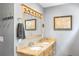 Bathroom showcasing double vanity with granite countertop, framed mirror, and decorative wall art at 2500 The Bent Twig, Seabrook Island, SC 29455