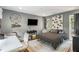 Bedroom featuring a mounted television, desk, and a stylish rug with queen sized bed at 2500 The Bent Twig, Seabrook Island, SC 29455