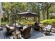 Outdoor deck with wicker furniture, umbrella and grill, surrounded by lush greenery at 2500 The Bent Twig, Seabrook Island, SC 29455