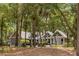 Home exterior showcases a backyard surrounded by mature trees and lush landscaping at 2500 The Bent Twig, Seabrook Island, SC 29455