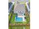 Aerial view showcasing a backyard with an in-ground pool, patio furniture, landscaping, and fenced yard at 256 Fiddleback Dr, Summerville, SC 29486