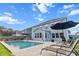 Backyard featuring an in-ground pool, patio furniture for lounging, manicured lawn, and beautiful landscaping at 256 Fiddleback Dr, Summerville, SC 29486