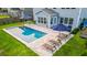 Backyard showcasing an in-ground pool, patio furniture for lounging, and a manicured lawn with green grass at 256 Fiddleback Dr, Summerville, SC 29486