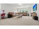 Spacious basement with carpet, a large sectional sofa, and a home theater setup at 256 Fiddleback Dr, Summerville, SC 29486