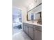 Bathroom vanity with neutral colored cabinets, countertops, decorative mirror and marble floors at 256 Fiddleback Dr, Summerville, SC 29486