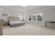 Spacious bedroom with tray ceiling, large windows, and neutral decor at 256 Fiddleback Dr, Summerville, SC 29486