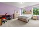 Bedroom featuring a wooden bed frame with a stripped comforter, wooden dresser, and lavender colored walls at 256 Fiddleback Dr, Summerville, SC 29486