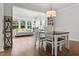 Bright dining room showcasing an open floor plan and hardwood floors with a view to the living area at 256 Fiddleback Dr, Summerville, SC 29486